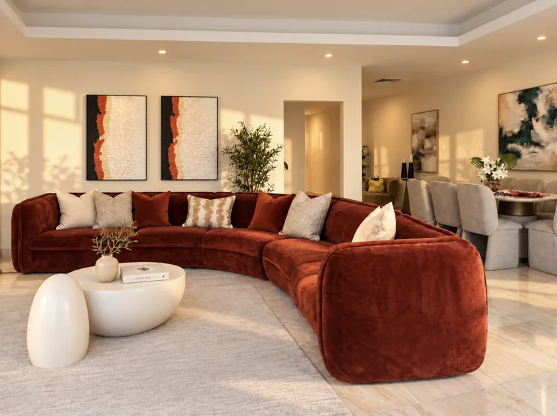 Horizon open-plan lounge with curved rust sofa and dining area beyond