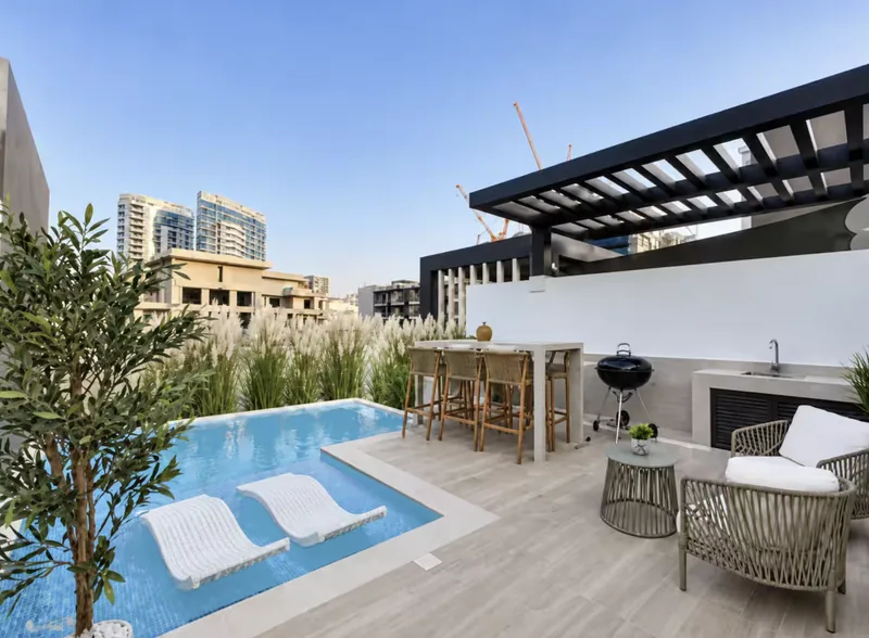 Mirage private rooftop pool with two in-pool loungers, pergola, bar with stools, BBQ grill and rattan armchairs