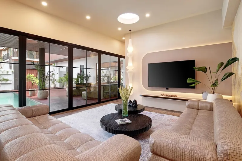 Seamlessly connected enclosed living room with direct pool access.