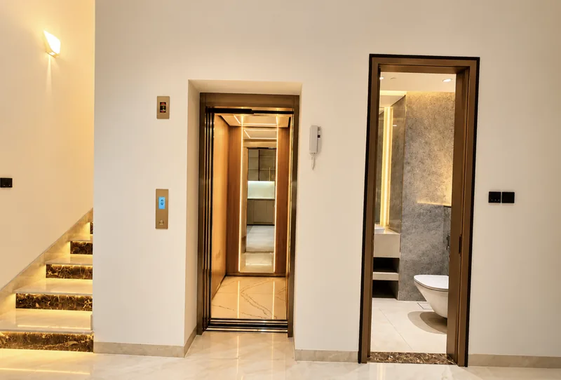 ParkView hallway with private lift, lit marble staircase and guest WC