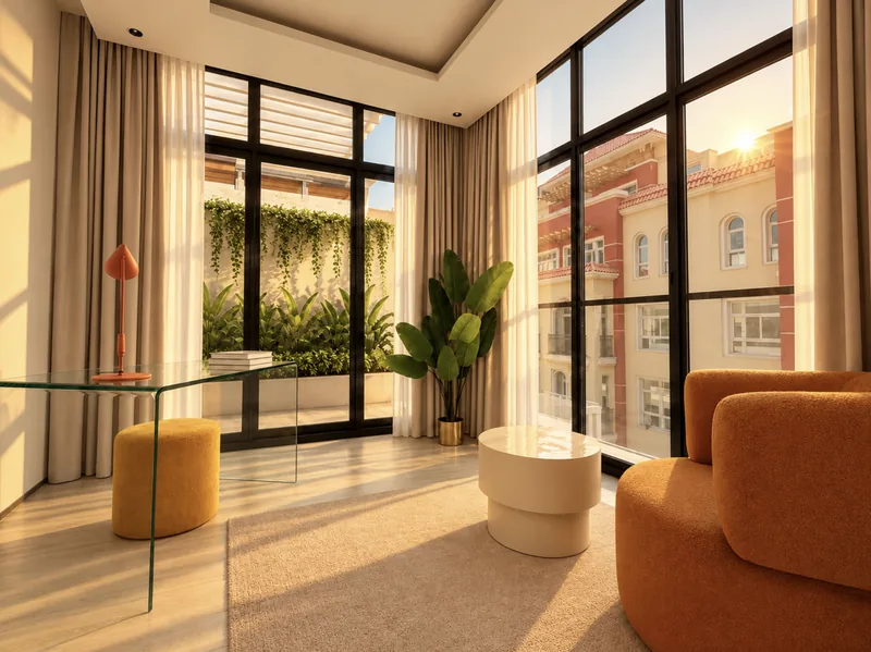 ParkView sitting room with glass desk, mustard pouf, orange boucle armchair and tall windows