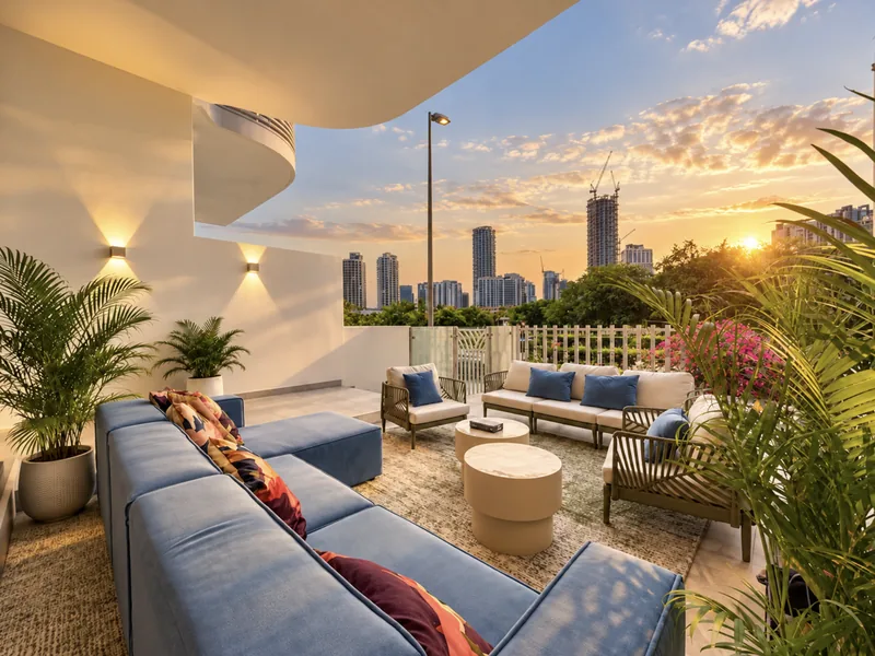 ParkView terrace lounge with blue sofas and outdoor seating, palms and bougainvillea, and the JVC skyline