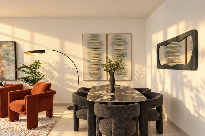 Zephyr dining area with marble table, grey chairs, arc floor lamp and rust armchairs